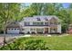 Beautiful two-story home with stone accents, a manicured lawn, and an attached two-car garage at 4152 Club Ne Dr, Atlanta, GA 30319