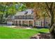 Charming two-story home with a manicured lawn, stone accents, and an attached two-car garage at 4152 Club Ne Dr, Atlanta, GA 30319