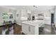 Bright kitchen features white cabinets, a marble island, stainless steel appliances, and a cozy breakfast nook at 4152 Club Ne Dr, Atlanta, GA 30319