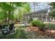 Secluded backyard featuring a creek, lush landscaping, seating, and mature trees at 5515 Cross Gate Ct, Sandy Springs, GA 30327