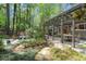 Spacious backyard with mature trees, patio with pergola, and tranquil pond creates a private outdoor oasis at 5515 Cross Gate Ct, Sandy Springs, GA 30327