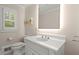 Powder room featuring a white vanity, sleek faucet, toilet, and neutral decor at 5515 Cross Gate Ct, Sandy Springs, GA 30327