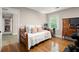 Cozy bedroom with hardwood floors, bright window, and a serene atmosphere, creating a welcoming and comfortable space at 5515 Cross Gate Ct, Sandy Springs, GA 30327