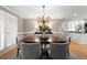 Elegant dining room featuring a chandelier, plantation shutters, and a view into the kitchen at 5515 Cross Gate Ct, Sandy Springs, GA 30327