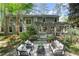 Beautiful two-story home with backyard featuring stone patio, pond with waterfall, and lush landscaping at 5515 Cross Gate Ct, Sandy Springs, GA 30327