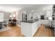 Open-concept kitchen with a center island, white cabinets, stainless steel appliances, and hardwood floors at 5515 Cross Gate Ct, Sandy Springs, GA 30327