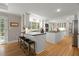 Spacious kitchen with a large island, seating, updated appliances, white cabinetry, and hardwood floors at 5515 Cross Gate Ct, Sandy Springs, GA 30327