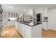 Bright kitchen with a center island, stainless steel appliances, and white cabinets and opens to dining room at 5515 Cross Gate Ct, Sandy Springs, GA 30327