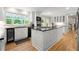 Updated kitchen with stainless appliances, a central island, wine storage, white cabinets, and hardwood floors at 5515 Cross Gate Ct, Sandy Springs, GA 30327
