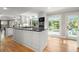 Bright kitchen featuring a center island, white cabinets, granite countertops, and stainless steel appliances at 5515 Cross Gate Ct, Sandy Springs, GA 30327