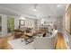 Open concept living room showcases hardwood floors, recessed lighting, and access to a kitchen at 5515 Cross Gate Ct, Sandy Springs, GA 30327