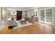 Elegant living room with hardwood floors, shuttered windows, and access to a patio at 5515 Cross Gate Ct, Sandy Springs, GA 30327