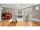 Bright living room with hardwood floors, piano, and comfortable seating at 5515 Cross Gate Ct, Sandy Springs, GA 30327