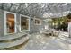 Back patio features stone floors, a covered pergola, with outdoor seating and access to home interior at 5515 Cross Gate Ct, Sandy Springs, GA 30327