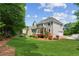 Large backyard featuring a well-manicured lawn and a view of the home's exterior at 7020 Weybridge Dr, Cumming, GA 30040