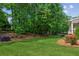Manicured backyard with lush lawn and mature trees, great for outdoor activities at 7020 Weybridge Dr, Cumming, GA 30040