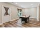 Basement features wood-look floor, a door with glass insert, and an air hockey table at 7020 Weybridge Dr, Cumming, GA 30040