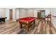Finished basement featuring a pool table and updated flooring for modern living at 7020 Weybridge Dr, Cumming, GA 30040
