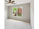Bedroom features plush neutral carpet and a double window showing green trees at 7020 Weybridge Dr, Cumming, GA 30040