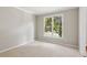 Neutral bedroom features carpeted flooring, a large window with pleasant natural light, and crisp white trim at 7020 Weybridge Dr, Cumming, GA 30040