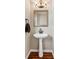 Small bathroom featuring unique fixtures, mirror, and tiled floors at 7020 Weybridge Dr, Cumming, GA 30040