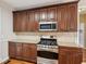 Elegant kitchen showcases stainless steel range, microwave, and beautiful dark wood cabinets at 7020 Weybridge Dr, Cumming, GA 30040