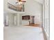 Open-concept living space with a soaring ceiling, fireplace, and a view of the kitchen and upstairs balcony at 7020 Weybridge Dr, Cumming, GA 30040