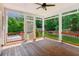 Covered porch with outdoor ceiling fan offering views of a lush, landscaped yard at 7020 Weybridge Dr, Cumming, GA 30040