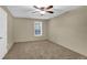 Bedroom featuring neutral walls, neutral carpet, ceiling fan, and a large window at 907 Country Park Se Dr, Smyrna, GA 30080
