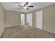 Spacious bedroom with neutral carpet and walls, ceiling fan, and two closets at 907 Country Park Se Dr, Smyrna, GA 30080