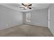 This cozy bedroom features a ceiling fan, neutral paint, and a window letting in natural light at 907 Country Park Se Dr, Smyrna, GA 30080