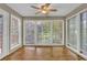 Cozy sun room featuring laminate floor, ceiling fan, and lots of natural light at 907 Country Park Se Dr, Smyrna, GA 30080