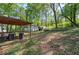 View of the backyard with a storage shed and trees at 92 Valley Se Trl, Acworth, GA 30101