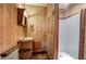 Bathroom features wood paneling, vanity, mirror, and step-in shower at 92 Valley Se Trl, Acworth, GA 30101