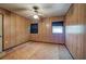 Bedroom with wood paneling, two windows, and exposed flooring ready for finishing at 92 Valley Se Trl, Acworth, GA 30101