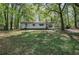 Quaint single story home featuring green awnings and a wooded yard at 92 Valley Se Trl, Acworth, GA 30101