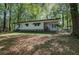 Quaint single-story home with white siding and a cozy covered front porch surrounded by mature trees at 92 Valley Se Trl, Acworth, GA 30101