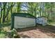 Green and white detached garage with a secondary storage building at 92 Valley Se Trl, Acworth, GA 30101
