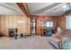 Living room showcasing wood paneling, fireplace, and view to hallway at 92 Valley Se Trl, Acworth, GA 30101