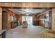 Open-concept living room with wood paneling, sliding glass door, and vintage decor at 92 Valley Se Trl, Acworth, GA 30101