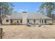 The exterior back of the home features a large patio and well manicured lawn at 1935 Knight Cir, Loganville, GA 30052