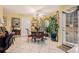 Bright dining area featuring a glass-top table, wrought iron chairs, and large windows with decorative curtains at 1935 Knight Cir, Loganville, GA 30052