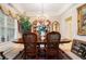 Elegant dining room with a tray ceiling, chandelier lighting, and formal furnishings at 1935 Knight Cir, Loganville, GA 30052