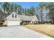 Well maintained single-story home with a long driveway leading to the attached two-car garage at 1935 Knight Cir, Loganville, GA 30052