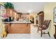 Spacious kitchen featuring custom wood cabinets, tile flooring, and a breakfast bar at 1935 Knight Cir, Loganville, GA 30052