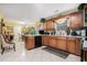 Open kitchen with wood cabinets and appliances, with access to the dining area at 1935 Knight Cir, Loganville, GA 30052