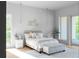 Well-lit bedroom with hardwood floors, modern light fixtures, large windows, and slider door access to deck at 2650 Fairoaks Rd, Decatur, GA 30033