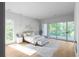 Bright bedroom featuring large windows, deck access, pendant lights, and hardwood floors at 2650 Fairoaks Rd, Decatur, GA 30033