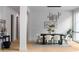 Contemporary dining area with modern lighting, black dining table, and six chairs on an area rug at 2650 Fairoaks Rd, Decatur, GA 30033