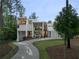 Modern home with clean lines, multiple balconies, and a long driveway, surrounded by trees at 2650 Fairoaks Rd, Decatur, GA 30033